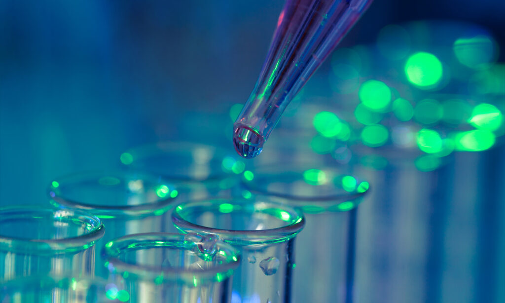 Pipette adding fluid to one of several test tubes