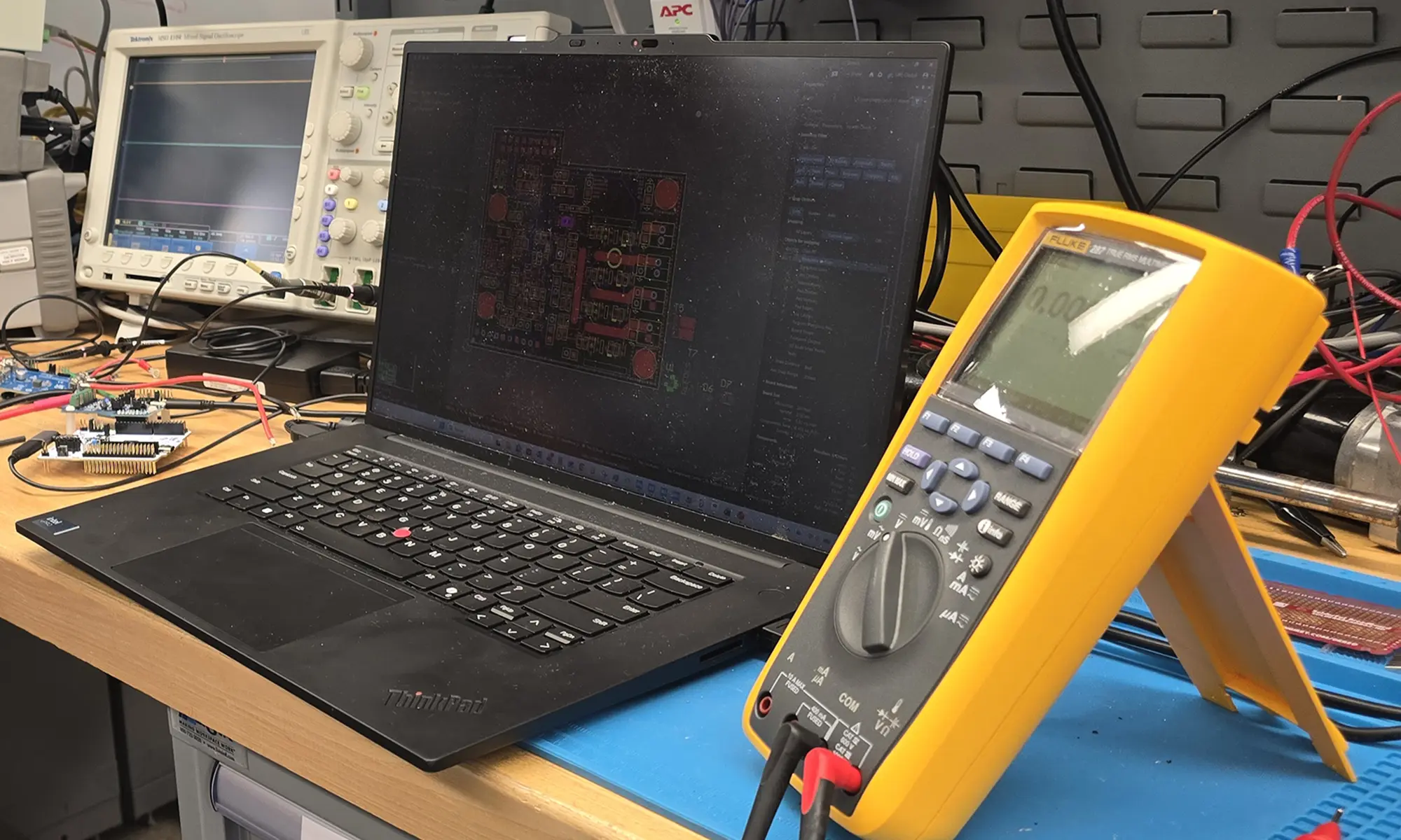 Laptop with electrical engineering equipment around it.