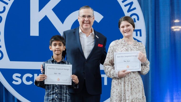 Ian Colrain posing with kids who won in the Kansas City Science Fain