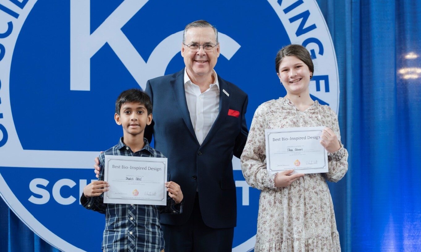 Ian Colrain posing with kids who won in the Kansas City Science Fain